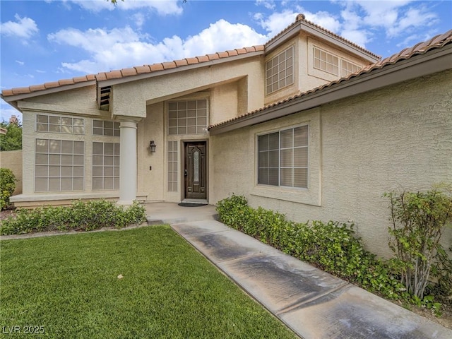 5452 Big Sky Ln, Las Vegas, NV 89149 - entrance to property featuring stucco siding, a yard, and a tiled roof
