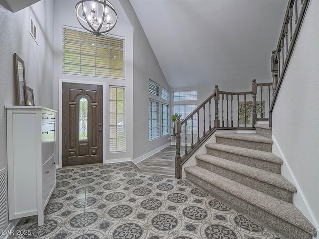5452 Big Sky Ln, Las Vegas, NV 89149 - foyer entrance featuring high vaulted ceiling, a chandelier, baseboards, and stairs