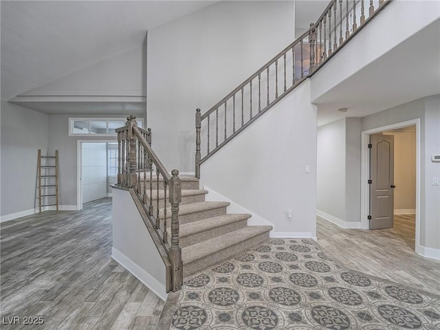 5452 Big Sky Ln, Las Vegas, NV 89149 - stairs with high vaulted ceiling, wood finished floors, baseboards, and french doors