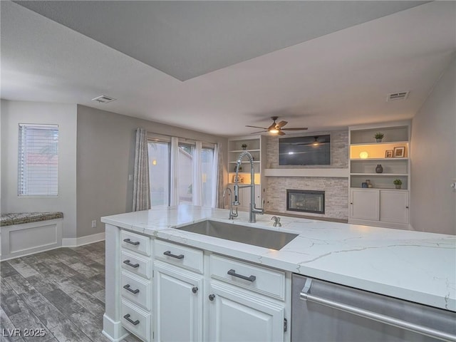 5452 Big Sky Ln, Las Vegas, NV 89149 - kitchen with a sink, dishwasher, a fireplace, dark wood-style flooring, and ceiling fan