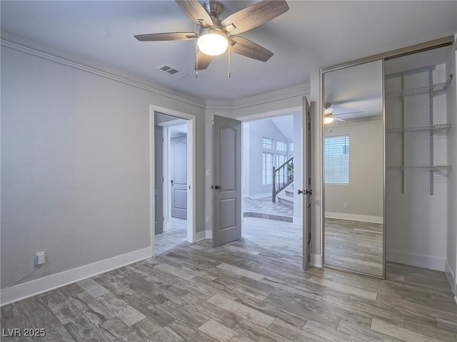 5452 Big Sky Ln, Las Vegas, NV 89149 - spare room with ceiling fan, ornamental molding, wood finished floors, baseboards, and stairway