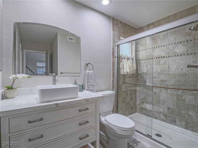 5452 Big Sky Ln, Las Vegas, NV 89149 - bathroom with a stall shower, a textured wall, toilet, and vanity