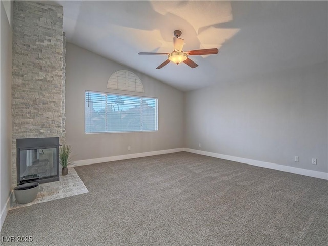 5452 Big Sky Ln, Las Vegas, NV 89149 - unfurnished living room with vaulted ceiling, a fireplace, carpet, a ceiling fan, and baseboards