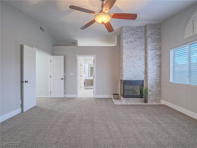 5452 Big Sky Ln, Las Vegas, NV 89149 - unfurnished living room featuring a stone fireplace, carpet, a ceiling fan, lofted ceiling, and baseboards