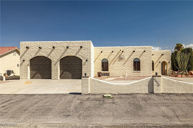 1320 Daytona St, Pahrump, NV 89048 - view of front of home featuring a garage, concrete driveway, and cooling unit
