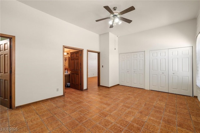1320 Daytona St, Pahrump, NV 89048 - unfurnished bedroom featuring multiple closets, a towering ceiling, ensuite bath, and tile patterned floors