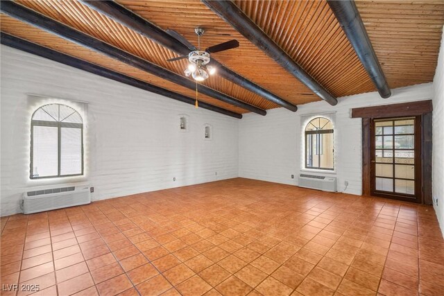 1320 Daytona St, Pahrump, NV 89048 - spare room featuring a ceiling fan, beamed ceiling, a wall unit AC, wooden ceiling, and light tile patterned flooring
