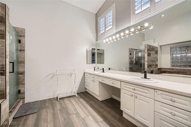5638 Wild Olive St, Las Vegas, NV 89118 - bathroom with a shower stall, lofted ceiling, double vanity, and wood finished floors