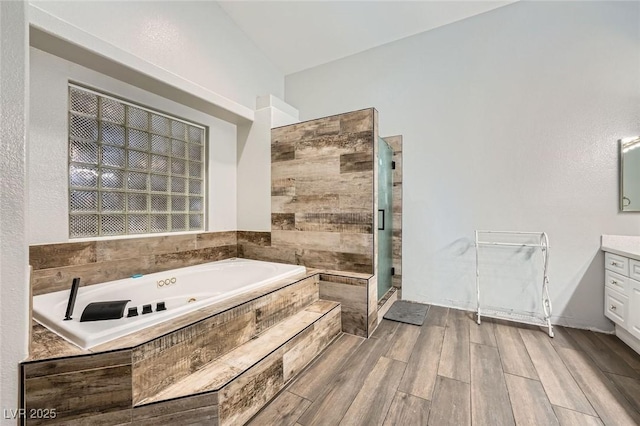 5638 Wild Olive St, Las Vegas, NV 89118 - bathroom with a shower stall, a whirlpool tub, vanity, and wood finished floors