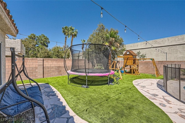 5638 Wild Olive St, Las Vegas, NV 89118 - view of yard featuring a trampoline, a playground, and a patio