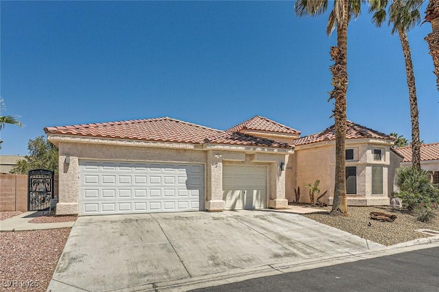 5638 Wild Olive St, Las Vegas, NV 89118 - mediterranean / spanish-style home with concrete driveway, a garage, a tiled roof, and stucco siding