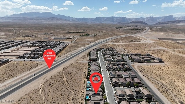 aerial view of residential area featuring mountains and a desert landscape