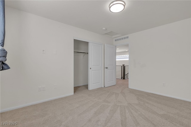 unfurnished bedroom with light colored carpet, a closet, and baseboards