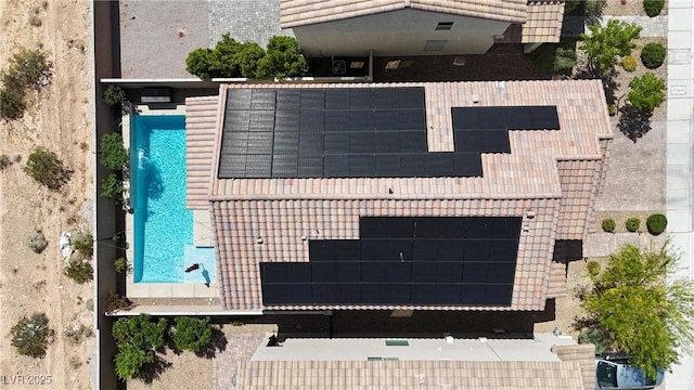 aerial view of property and surrounding area featuring a pool area