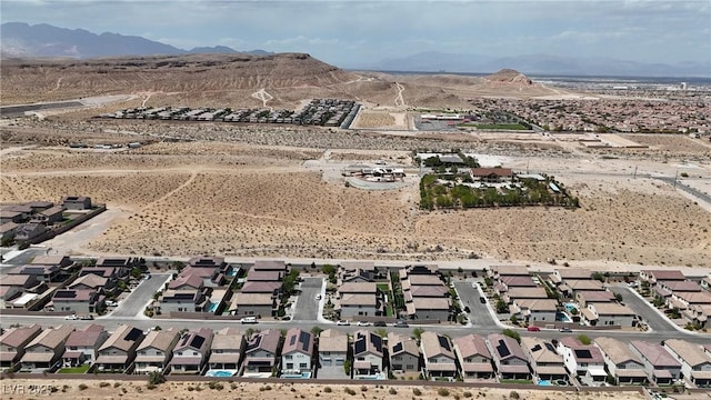 aerial perspective of suburban area featuring a mountainous background and a desert landscape