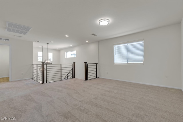 unfurnished room featuring light carpet, baseboards, and recessed lighting