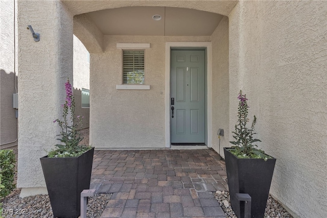 entrance to property with stucco siding