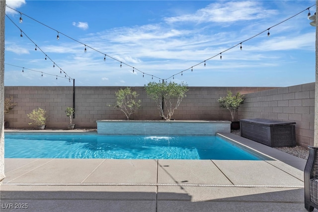 view of pool with a fenced backyard