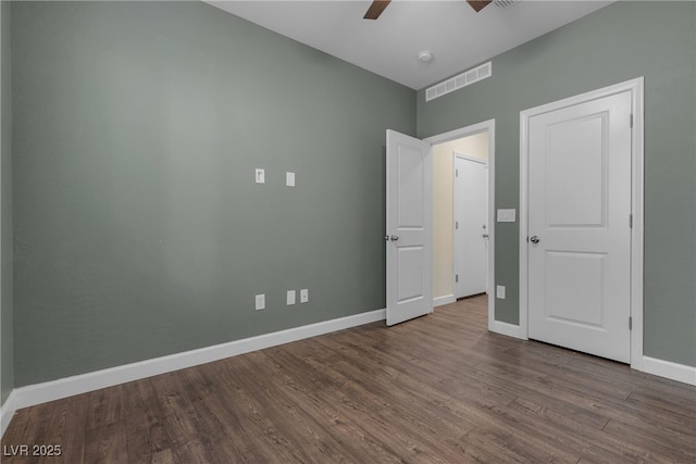 unfurnished bedroom featuring wood finished floors, baseboards, and ceiling fan
