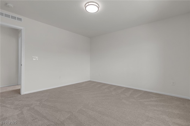 unfurnished room featuring carpet floors, baseboards, and a smoke detector