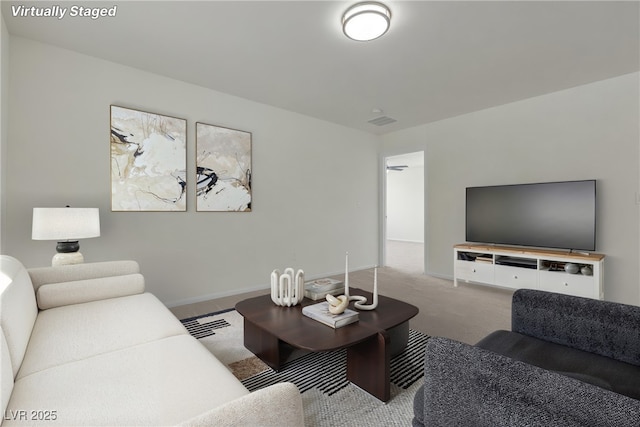 living area featuring carpet flooring and baseboards