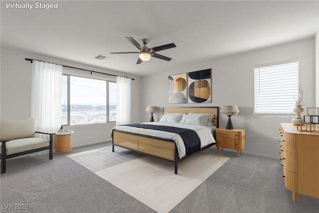 bedroom featuring carpet, baseboards, and a ceiling fan