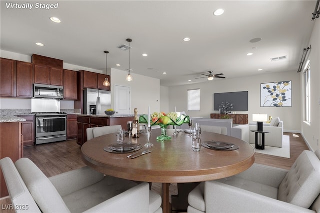 dining space with dark wood-style flooring, recessed lighting, and a ceiling fan