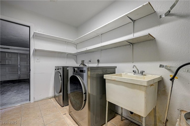 1620 Yellow Rose St, Las Vegas, NV 89108 - laundry area with washing machine and clothes dryer and light tile patterned flooring