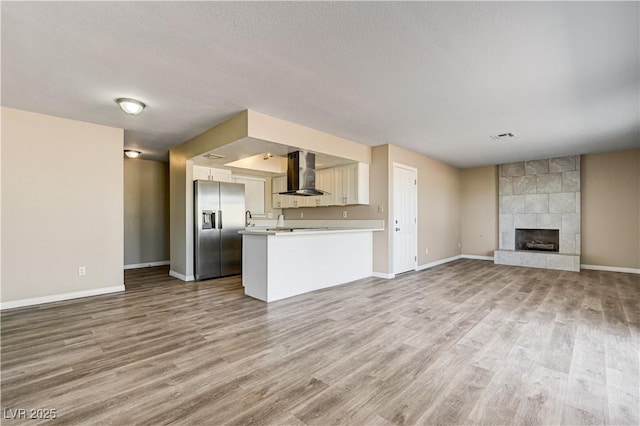 1620 Yellow Rose St, Las Vegas, NV 89108 - unfurnished living room featuring wood finished floors, baseboards, a fireplace, and a textured ceiling