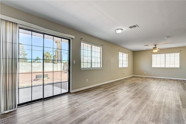 1620 Yellow Rose St, Las Vegas, NV 89108 - spare room featuring wood finished floors, baseboards, ceiling fan, and a textured ceiling