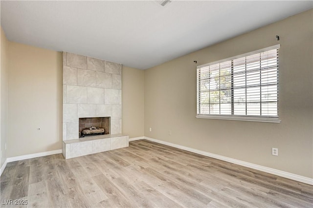 1620 Yellow Rose St, Las Vegas, NV 89108 - unfurnished living room featuring light wood-type flooring, baseboards, and a tile fireplace