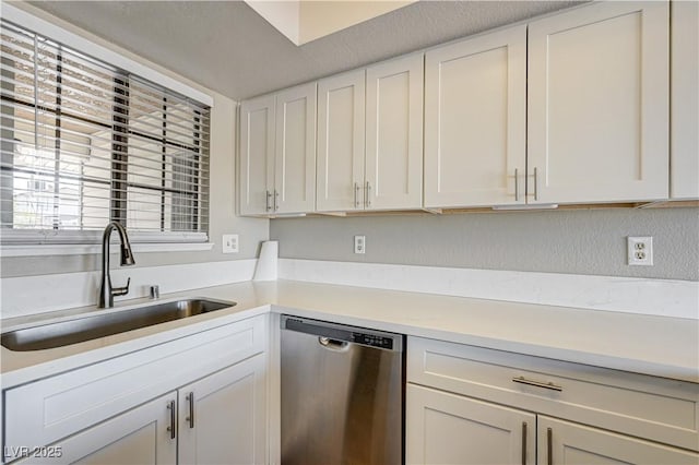 1620 Yellow Rose St, Las Vegas, NV 89108 - kitchen featuring dishwasher, a sink, light countertops, white cabinets, and a textured wall