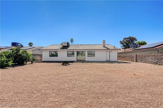 1620 Yellow Rose St, Las Vegas, NV 89108 - rear view of property featuring a chimney, central AC, a fenced backyard, and metal roof