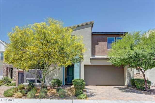 8335 Beaten Path Ct, Las Vegas, NV 89166 - view of front of property with a garage, stucco siding, and decorative driveway