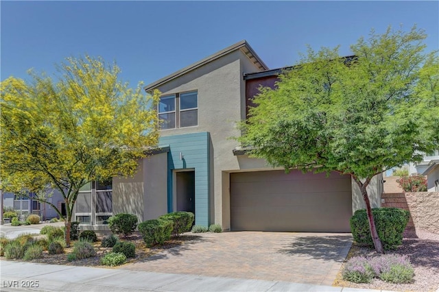 8335 Beaten Path Ct, Las Vegas, NV 89166 - view of front facade featuring a garage, decorative driveway, and stucco siding
