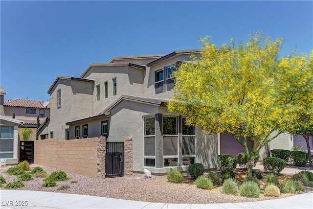 8335 Beaten Path Ct, Las Vegas, NV 89166 - view of front of property with stucco siding and a gate