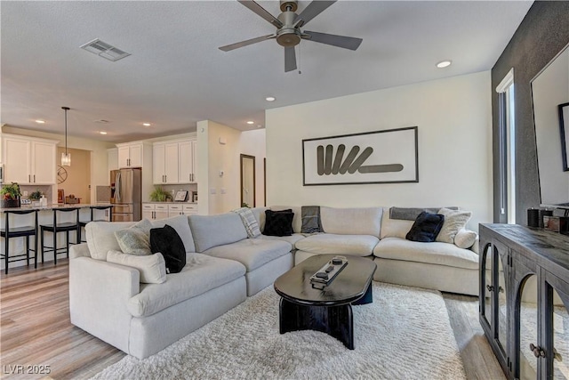 8335 Beaten Path Ct, Las Vegas, NV 89166 - living area with light wood-type flooring, ceiling fan, and recessed lighting