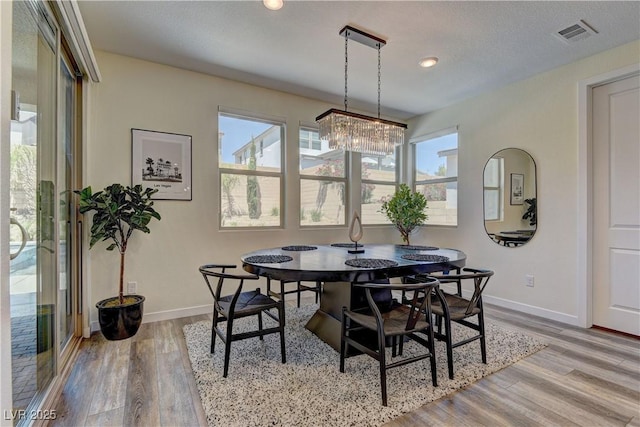 8335 Beaten Path Ct, Las Vegas, NV 89166 - dining room featuring healthy amount of natural light, light wood-type flooring, baseboards, and recessed lighting