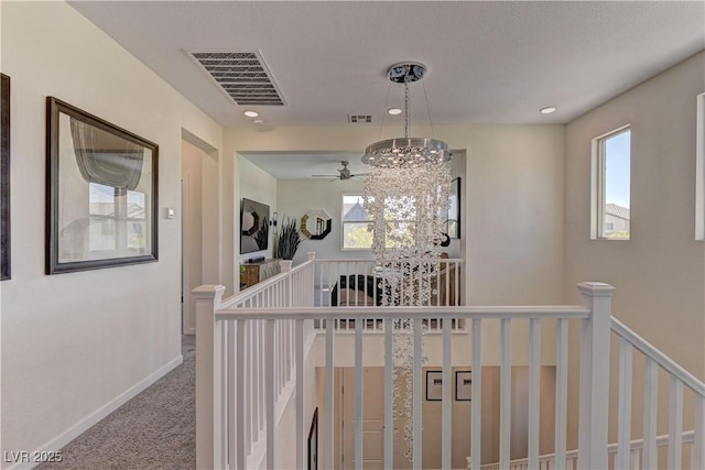 8335 Beaten Path Ct, Las Vegas, NV 89166 - hall featuring an upstairs landing, carpet flooring, a chandelier, and baseboards