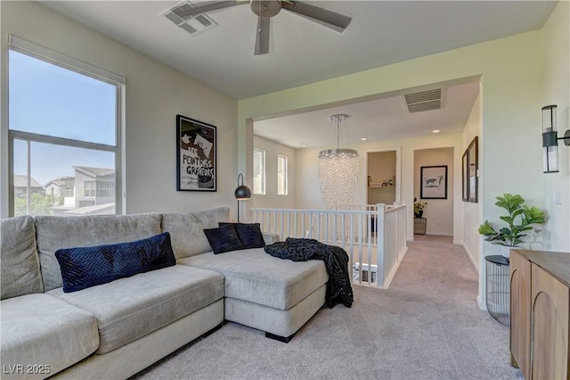 8335 Beaten Path Ct, Las Vegas, NV 89166 - living room featuring light colored carpet, ceiling fan, a chandelier, and baseboards