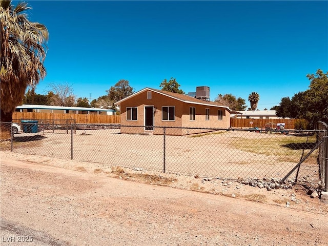 single story home featuring fence, stucco siding, and central AC unit