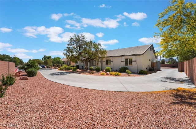 8125 Soledad Canyon St, Las Vegas, NV 89131 - view of property exterior with fence, curved driveway, and stucco siding