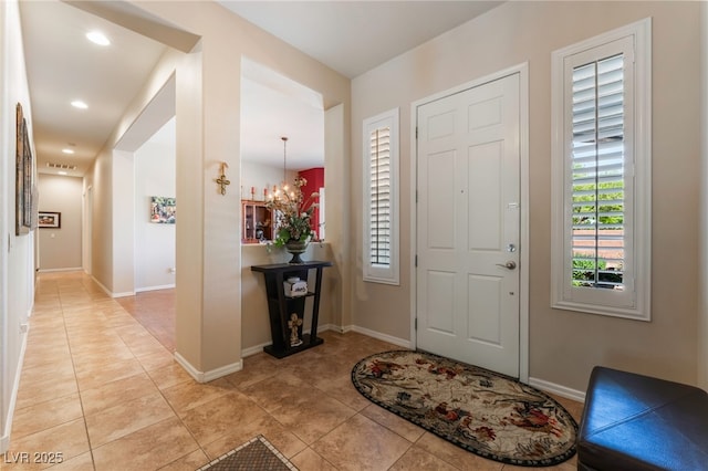 8125 Soledad Canyon St, Las Vegas, NV 89131 - entryway featuring light tile patterned flooring, a chandelier, and baseboards