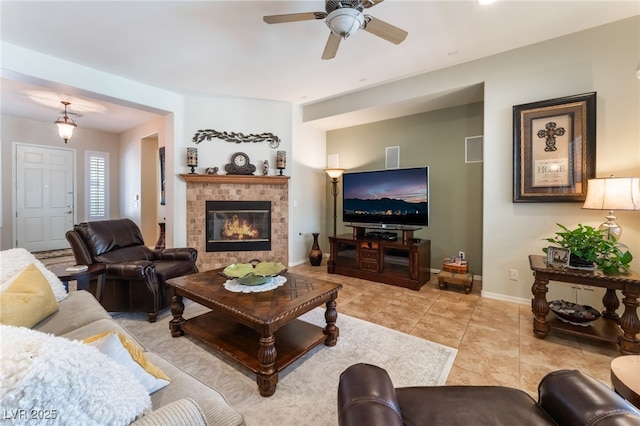 8125 Soledad Canyon St, Las Vegas, NV 89131 - living area featuring a ceiling fan, baseboards, a fireplace, and light tile patterned floors