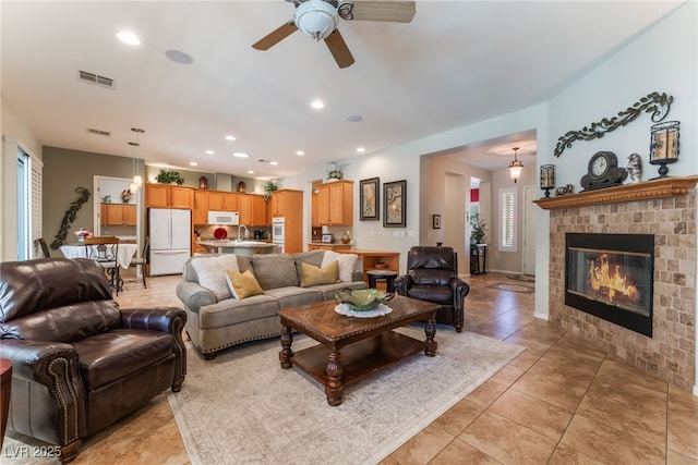8125 Soledad Canyon St, Las Vegas, NV 89131 - living room with a ceiling fan, a brick fireplace, light tile patterned flooring, and recessed lighting