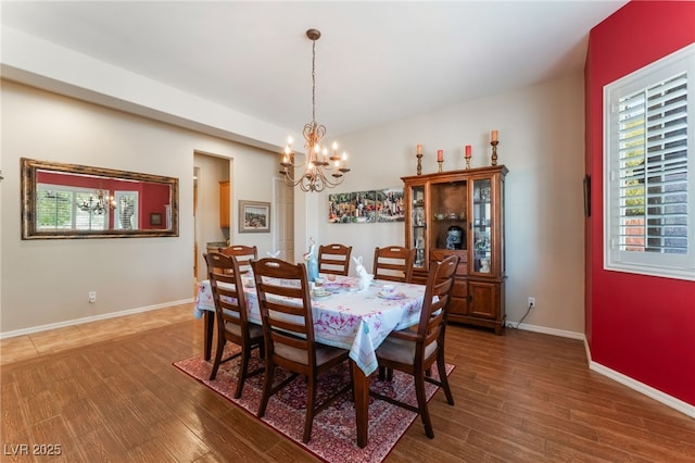 8125 Soledad Canyon St, Las Vegas, NV 89131 - dining room featuring a chandelier, wood finished floors, and baseboards