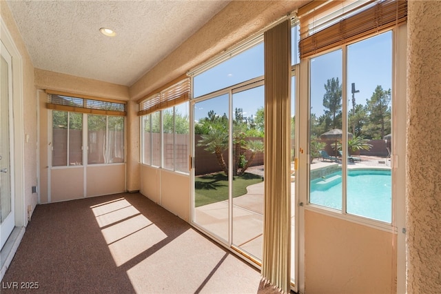 8125 Soledad Canyon St, Las Vegas, NV 89131 - unfurnished sunroom with a textured ceiling, carpet floors, and recessed lighting
