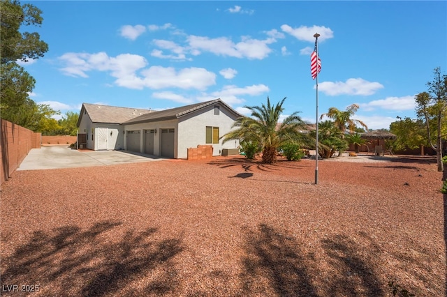 8125 Soledad Canyon St, Las Vegas, NV 89131 - back of house with driveway, fence, stucco siding, and a garage