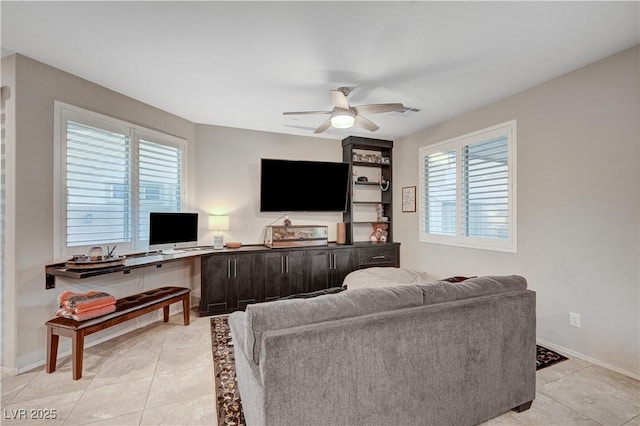 9327 S Chieftain St, Las Vegas, NV 89178 - living room featuring ceiling fan, light tile patterned floors, an office area, and baseboards