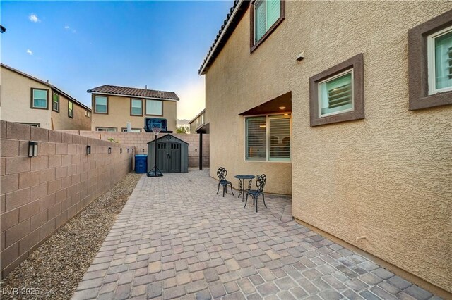 9327 S Chieftain St, Las Vegas, NV 89178 - view of patio with a storage unit, a fenced backyard, and an outdoor structure